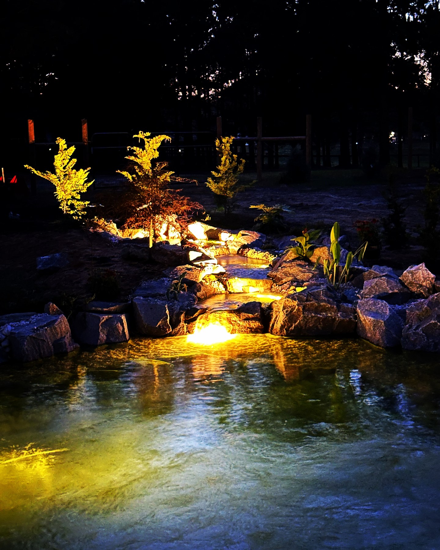 Carolina Water Gardens waterfall lit in the evening
